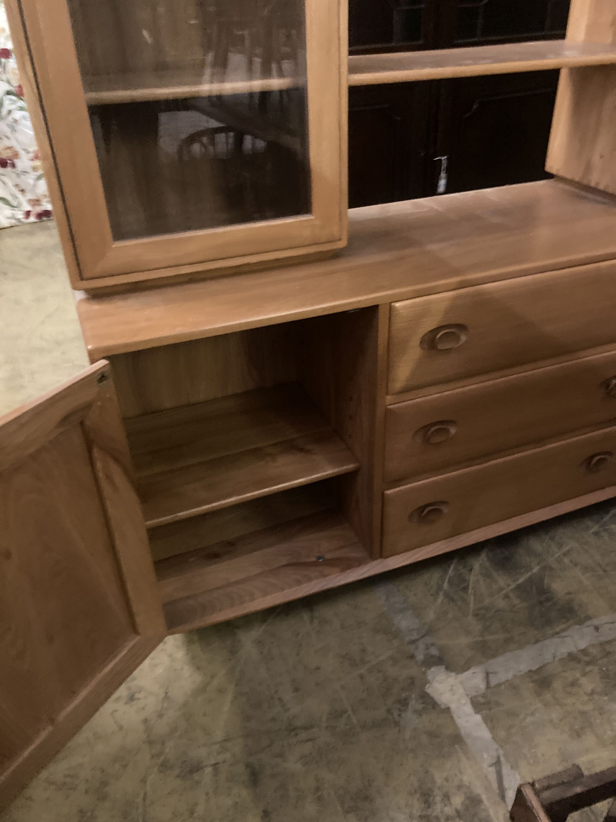 An Ercol elm glazed bookcase, width 155cm depth 44cm height 162cm